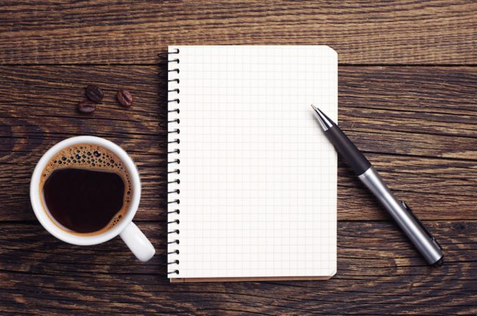 Cup of coffee and notepad