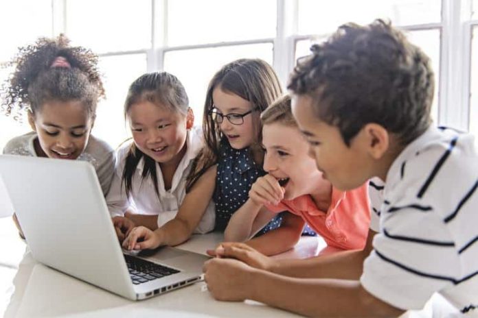 A-group-of-kids-using-a-laptop